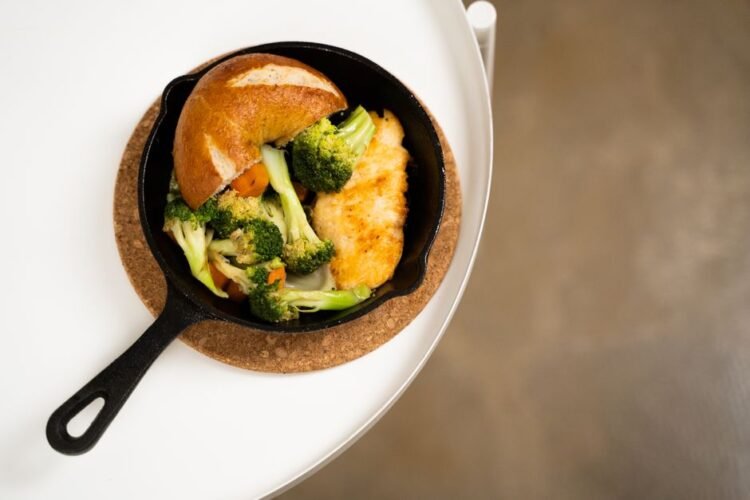 Blackened Chicken Thighs with Bourbon-Molasses Glaze, Spoonbread, and Braised Collards
