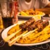 Greek Pork Souvlaki Pitas with Whipped Feta, Charred Lemon, and Quick Pickled Red Onion