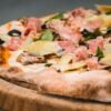 Italian Four Seasons Pizza with Artichokes, Mushrooms, Ham, and Olives
