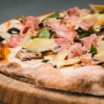 Italian Four Seasons Pizza with Artichokes, Mushrooms, Ham, and Olives