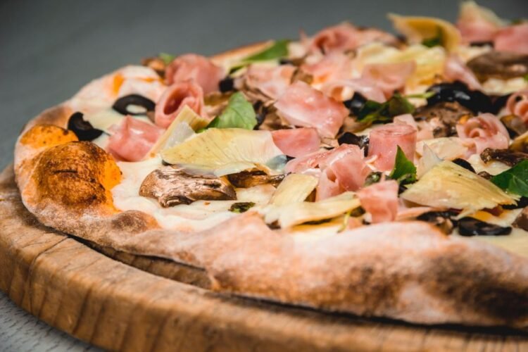 Italian Four Seasons Pizza with Artichokes, Mushrooms, Ham, and Olives