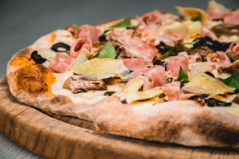 Italian Four Seasons Pizza with Artichokes, Mushrooms, Ham, and Olives