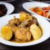 Jamaican Brown Stew Chicken with Coconut Dumplings, Callaloo, and Fried Plantains