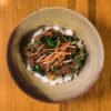 Korean Bulgogi Skirt Steak with Charred Scallions, Crispy Garlic Rice, and Gochujang-Honey Butter