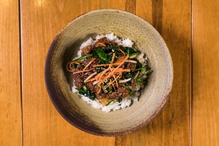 Korean Bulgogi Skirt Steak with Charred Scallions, Crispy Garlic Rice, and Gochujang-Honey Butter