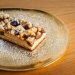 Olive Oil Cake with Roasted Plums, Amaretti Crumble, and Mascarpone Cream