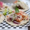 Smoky Chicken Tinga Tacos with Charred Corn-Poblano Slaw and Crispy Cheese Skirt