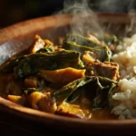 Congolese cassava leaf stew with beef, smoked fish and rice