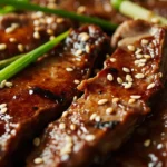 Korean Bulgogi Skirt Steak with Charred Scallions, Crispy Garlic Rice, and Gochujang-Honey Butter