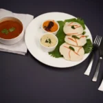 Steamed rice cakes with sambar and chutneys