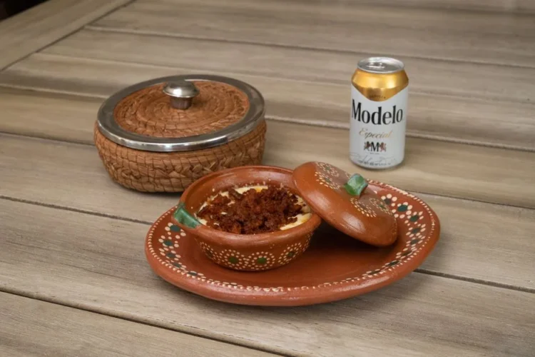 Warm bean dip with chorizo in a clay pot