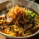 Filipino lomi thick egg noodle soup with pork
